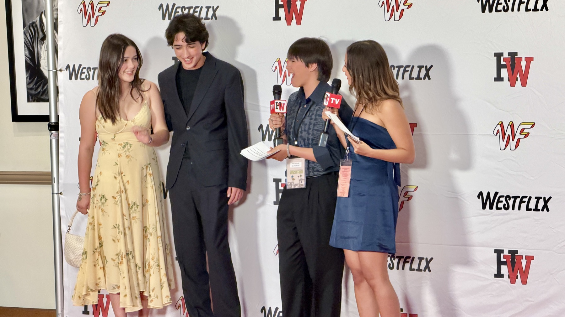 The cast of Instant interviewed on the Westflix step-and-repeat